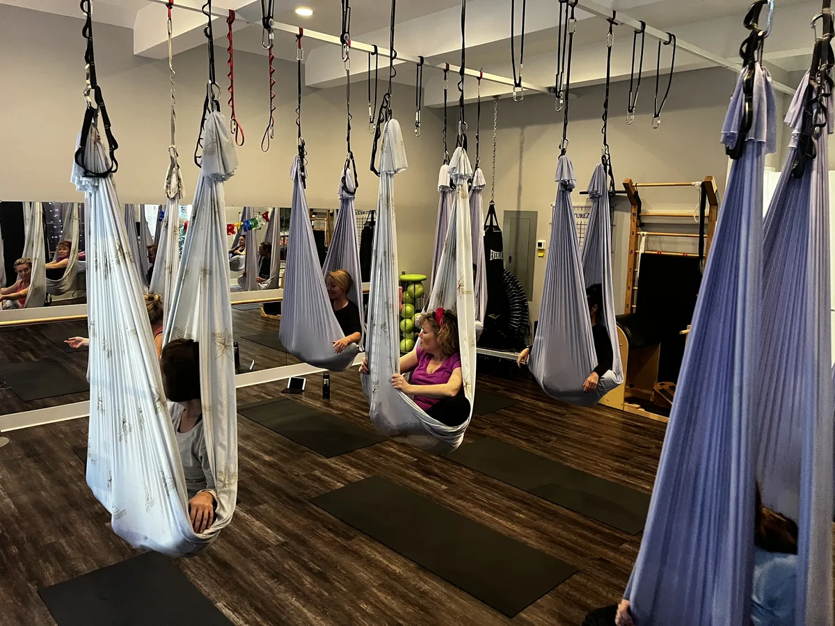 AntiGravity® aerial hammock studio at Dancing Hammock — row of hanging silk hammocks