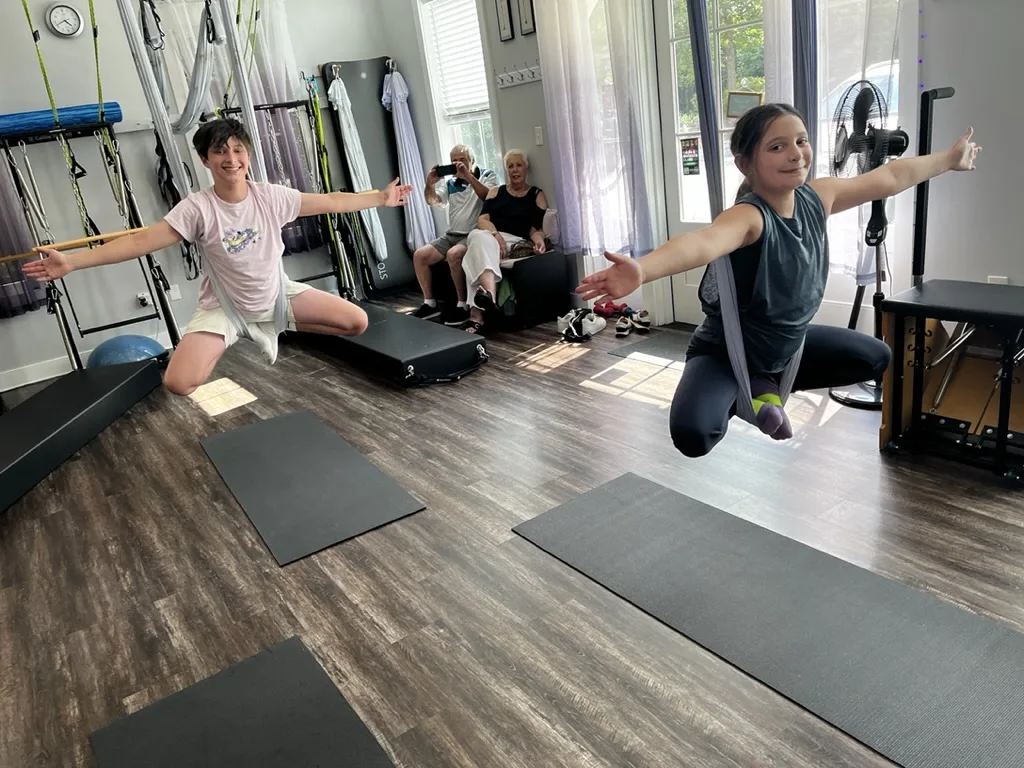 AntiGravity® aerial fitness event at Dancing Hammock — young participants flying in hammocks